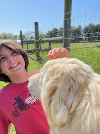 a boy with a dog in a field